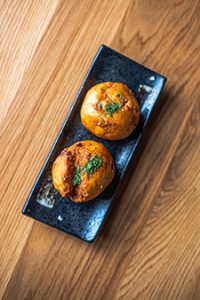 Steamed bao filled with crunchy pork, herbs, and pickled vegetables