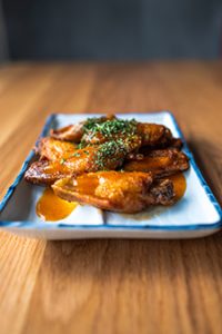 Crispy chicken wings glazed in mango habanero sauce